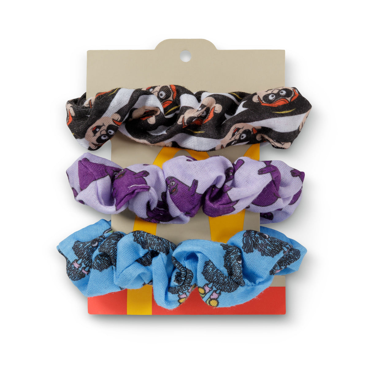 Multi Pack on Brown backer: Black and white Hamburglar Scrunchie, Lavendar and Purple Grimace Scrunchie, Sky blue Blue Fry Friend scrunchie