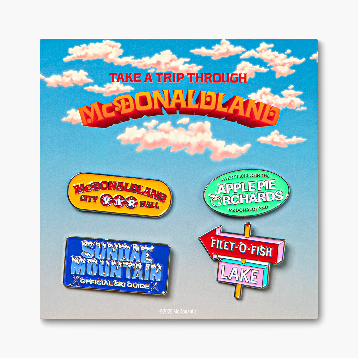 Set of 4 McDonaldland enamel pins on branded backer card packaging that reads "Take a Trip Through McDonaldland