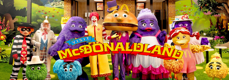 McDonaldland Characters with 'Visit McDonaldland' in Red and Yellow Text in center.