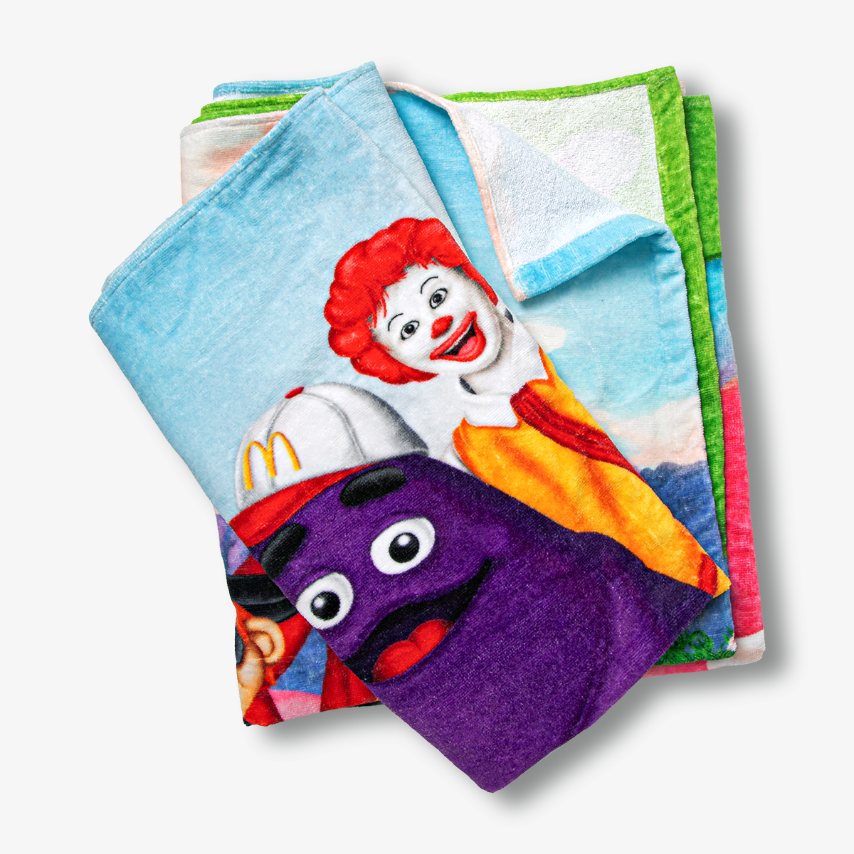 Folded McDonaldland summer towel with close-up view of Grimace and Ronald McDonald's faces