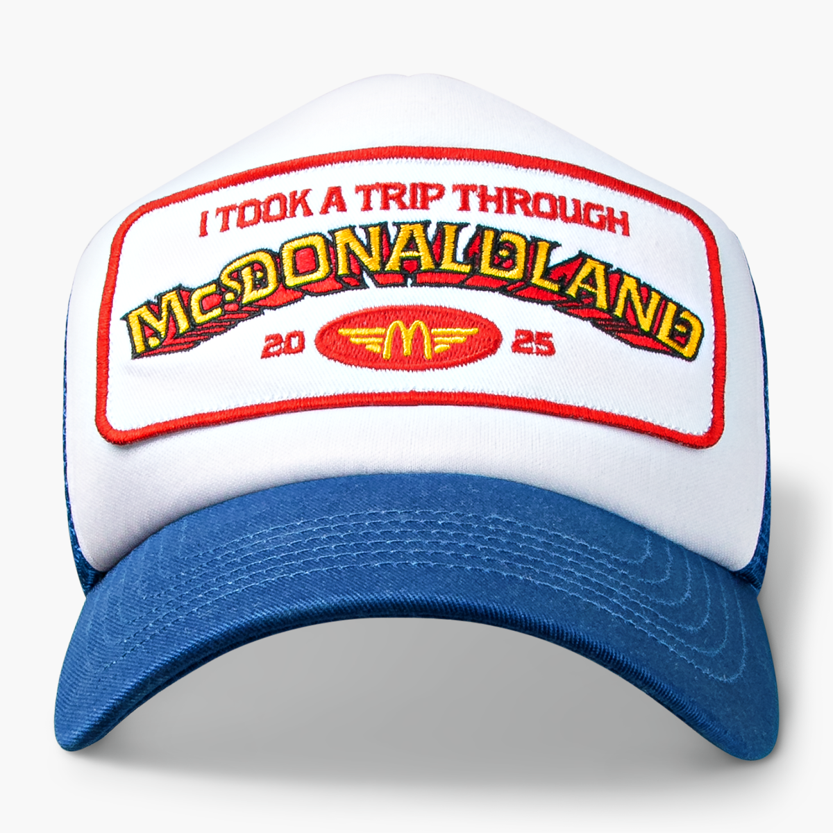 Front view of hat with red and gold embroidered text that reads "I Took a Trip Through McDonaldland" with the year 2025 separated by a gold and red McDonald's emblem