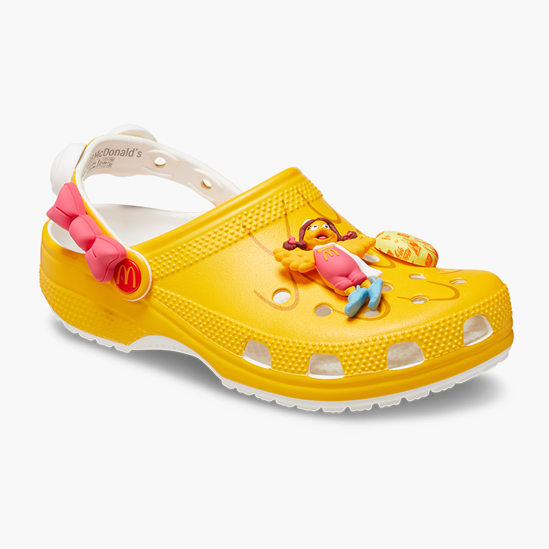 Yellow Birdie Crocs Clog with Pink Bow on strap and Birdie Jibbitz and Egg McMuffin Jibbitz.