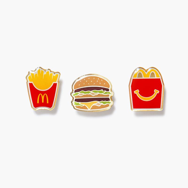 three pin set includes McDonald's fry box, Big Mac burger, and Happy Meal