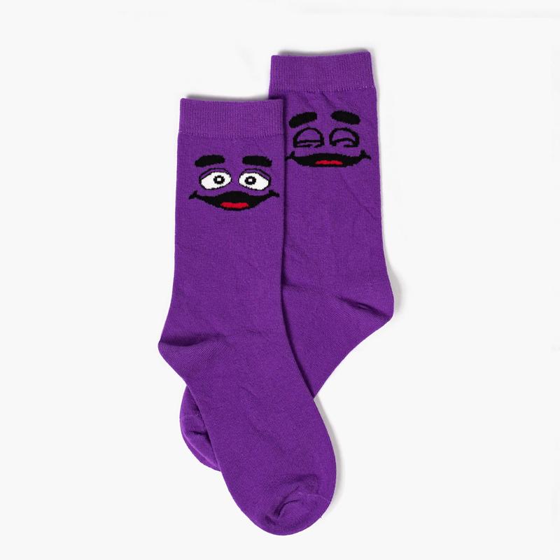 Royal purple ankle socks with Grimace eyes open on the right ankle and Grimace eyes closed on the left ankle