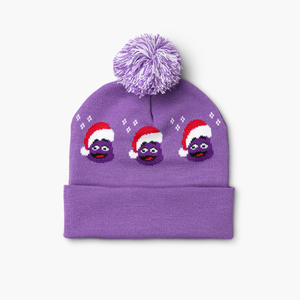 Back of purple and white pom beanie with repeating Grimace pattern and dual-color pom on top.