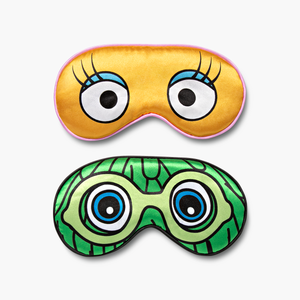 Set of 2 sleep masks. 1 Yellow mask featuring Birdie's eyes and lashes and 1 Green mask featuring the green Fry Friend's wacky hair, eyes and goggles.