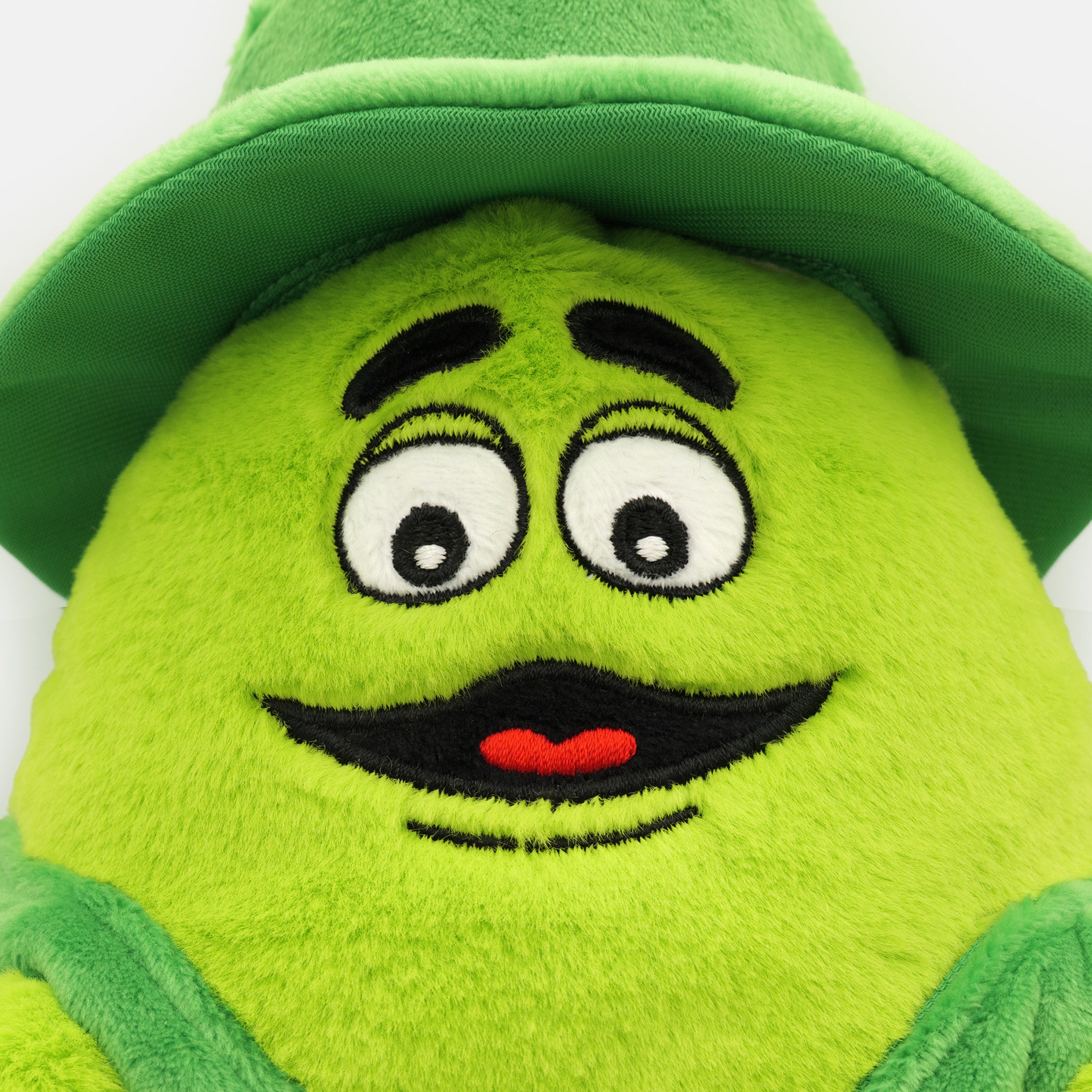 Close Up Uncle O’Grimacey plush toy in bright green with embroidered face, shamrock vest, and matching green hat