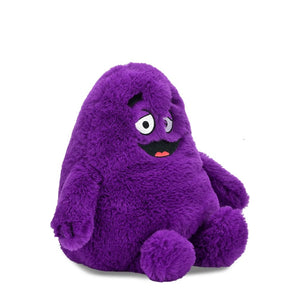 Angled front view of the Grimace Phunny Plush by Kidrobot showing Grimace seated with embroidered facial details.