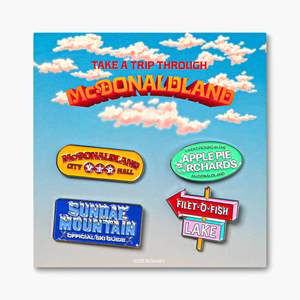 Set of 4 McDonaldland enamel pins on branded backer card packaging that reads "Take a Trip Through McDonaldland