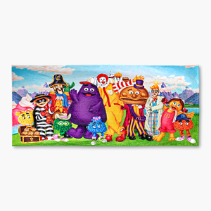Full view of a beach towel with the iconic McDonaldland characters posing together in front of Sundae Mountain
