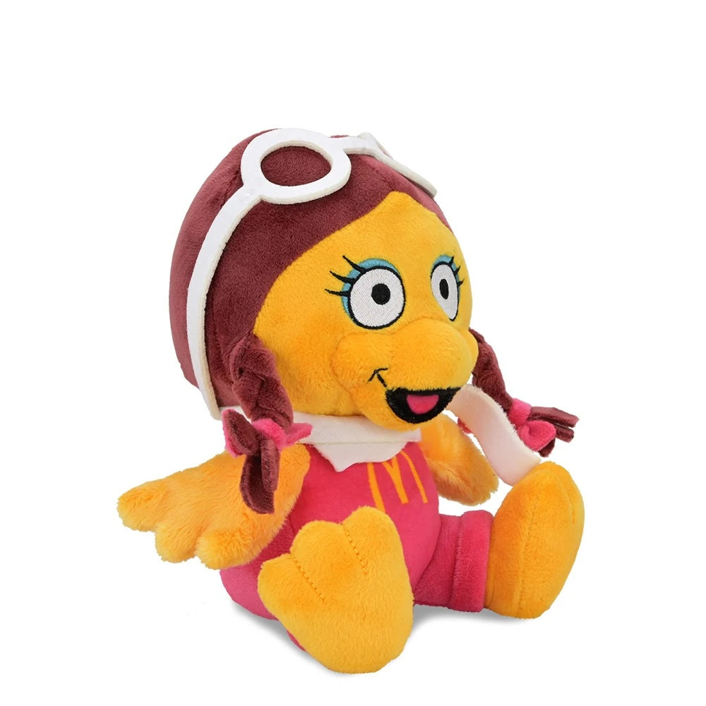 Angled front view of Birdie Phunny Plush by Kidrobot showing the pink jumpsuit, white scarf, goggles, and braided pigtails.