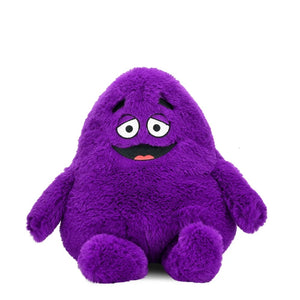 Front view of the Grimace Phunny Plush by Kidrobot, featuring a purple plush character with embroidered eyes, eyebrows, smile, and seated legs.