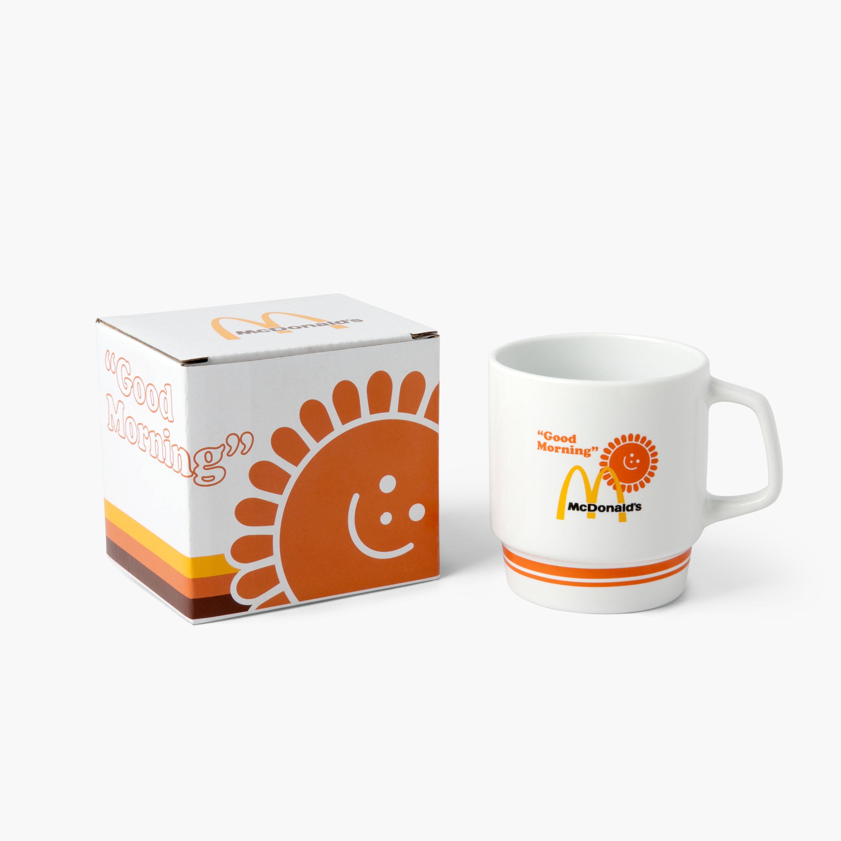  The mug next to a matching box featuring the same orange smiling sun