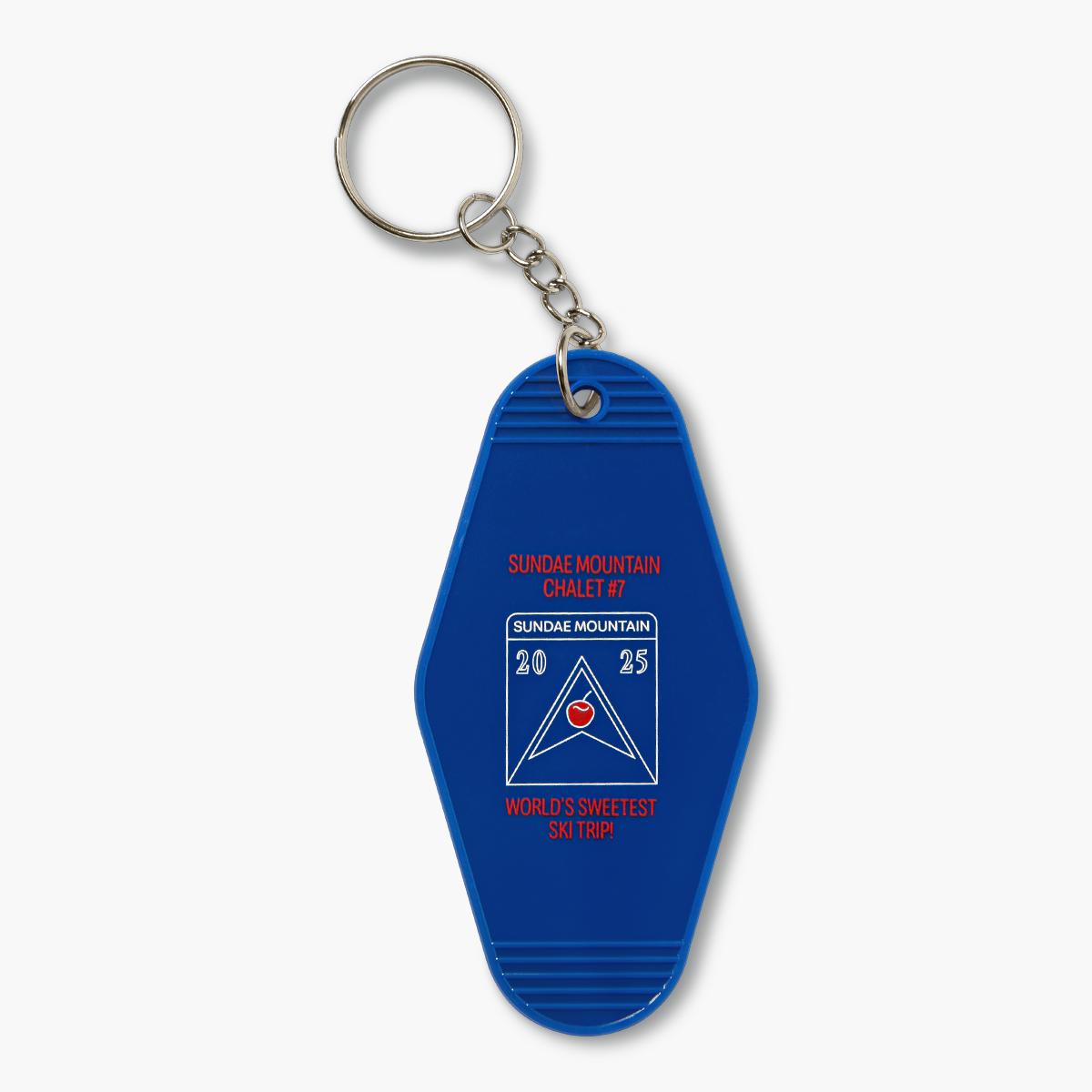 Blue keychain with white-outlined Sundae Mountain logo with the year 2025 and red text that reads "Sundae Mountain Chalet #7.  World's Sweetest Ski Trip!"