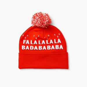 Back of red-and-white pom beanie with repeating “Fa La La…” text and festive pom on top.