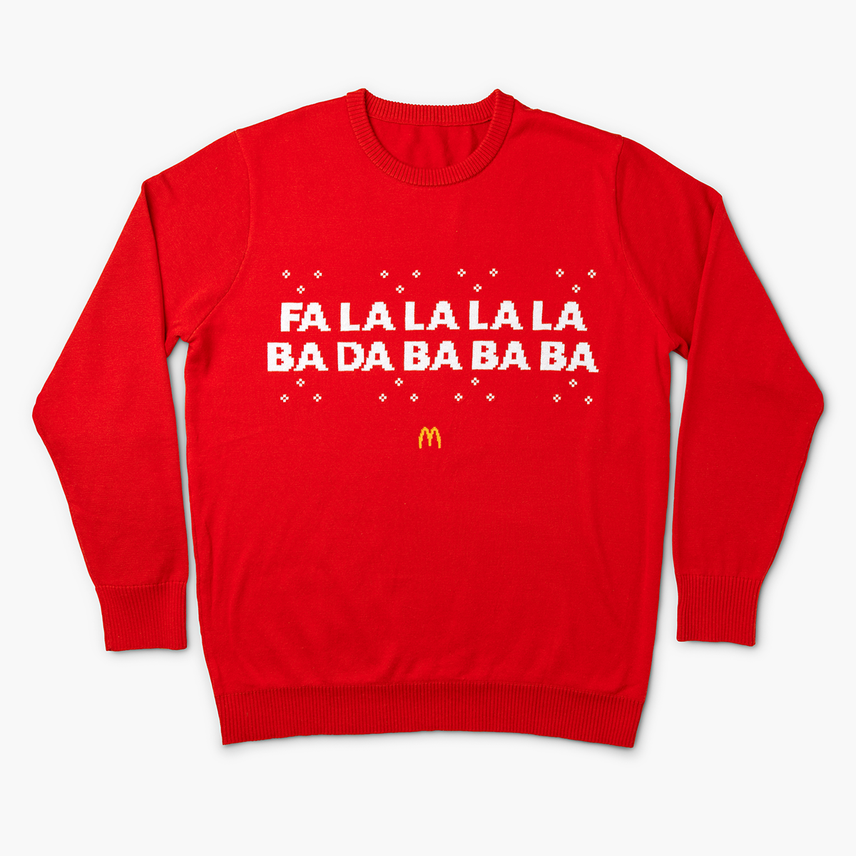 Front view of red holiday sweater with white text that reads “Fa La La La La Ba Da Ba Ba Ba” and a small yellow McDonald’s Golden Arches logo below.