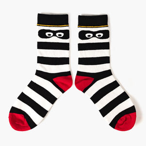 Striped black and white ankle socks with red toes and heels and Hamburglar eyes on the ankle
