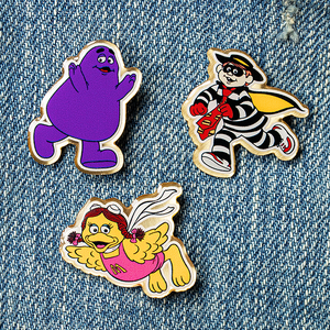 Enamel McDonaldland Pins on Denim Background