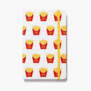 white journal with McDonald's fry pattern and yellow elastic strap closure