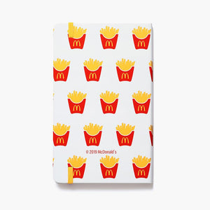 white journal with McDonald's fry pattern and yellow elastic strap closure