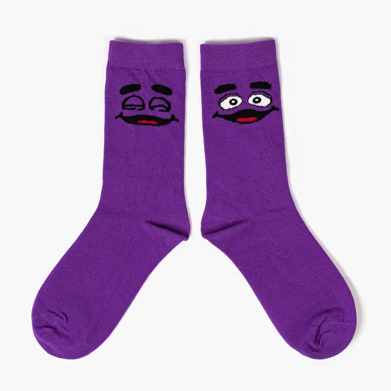 Royal purple ankle socks with Grimace eyes open on the right ankle and Grimace eyes closed on the left ankle